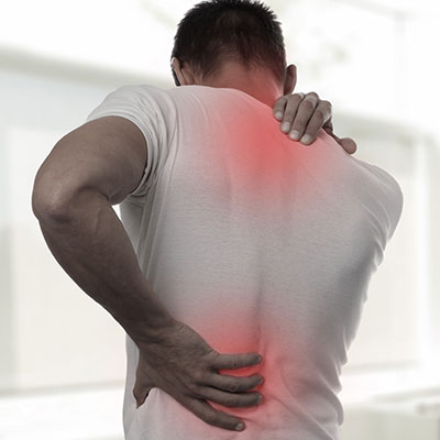 man holding back and neck in pain