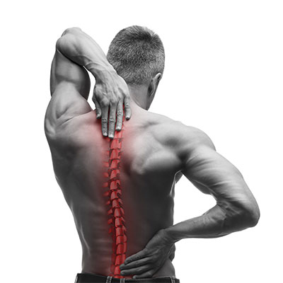 Medical illustration of illuminated spine with man holding back