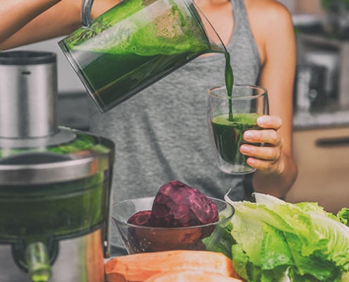 woman pouring fresh made juice for her detox